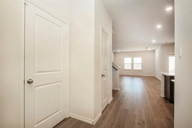 a view of hallway with wooden floor