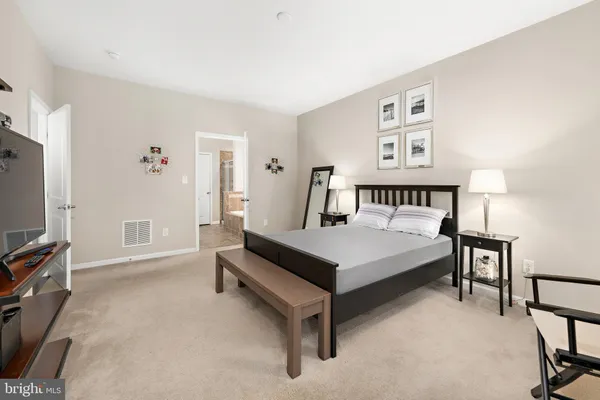 a bedroom with a bed next to a window with a tv