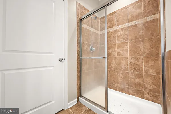 a bathroom with a glass shower door