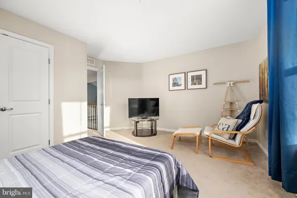 a bedroom with a bed and a tv