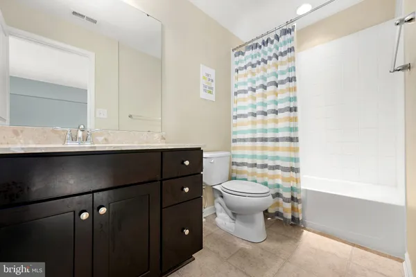 a bathroom with a sink a toilet a shower and a mirror