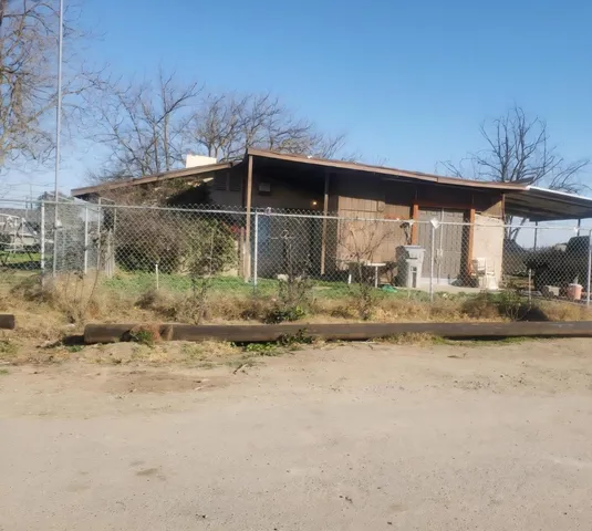 a view of a wooden house with a yard