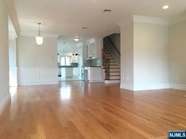 a view of a kitchen with wooden floor and a window