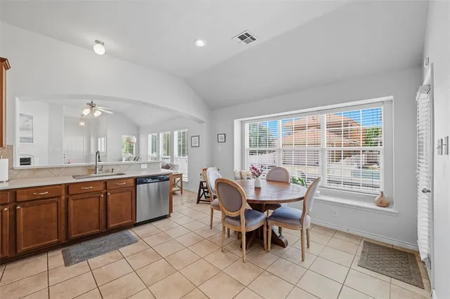 a dining room with granite countertop a sink table and chairs