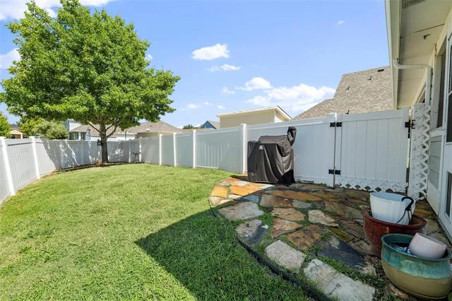 an aerial view of a house with garden space and sitting area