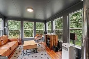 a living room with furniture and a floor to ceiling window