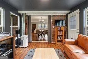 a living room with furniture a wooden floor and a fireplace