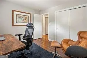 a view of a workspace with furniture and lounge chair