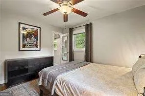 a bedroom with a large bed and a chandelier