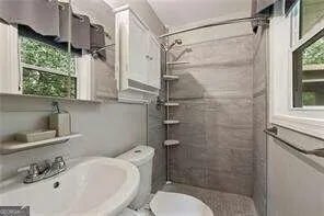 a bathroom with a sink toilet and shower