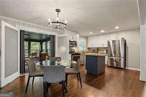 a view of kitchen with refrigerator and window