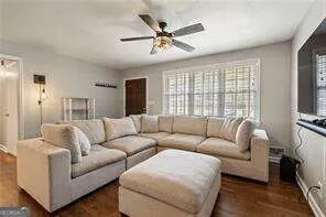 a living room with furniture and a flat screen tv