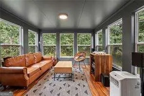 a living room with furniture and a floor to ceiling window