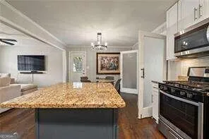 a kitchen with granite countertop wooden cabinets and stainless steel appliances