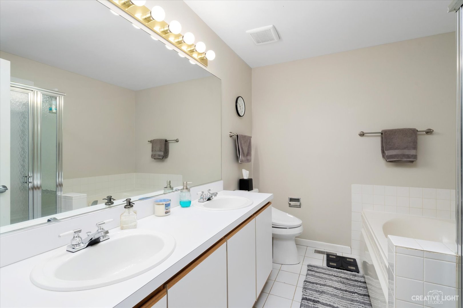 1180 Coldspring Road Elgin, IL 60120 - Photo 13 of 18 a bathroom with a sink a toilet and shower curtain