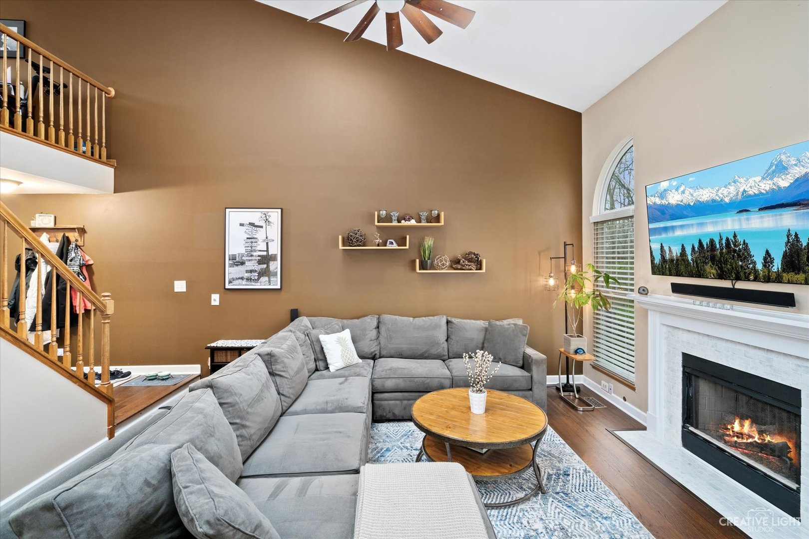 1180 Coldspring Road Elgin, IL 60120 - Photo 4 of 18 a living room with furniture a fireplace and a flat screen tv