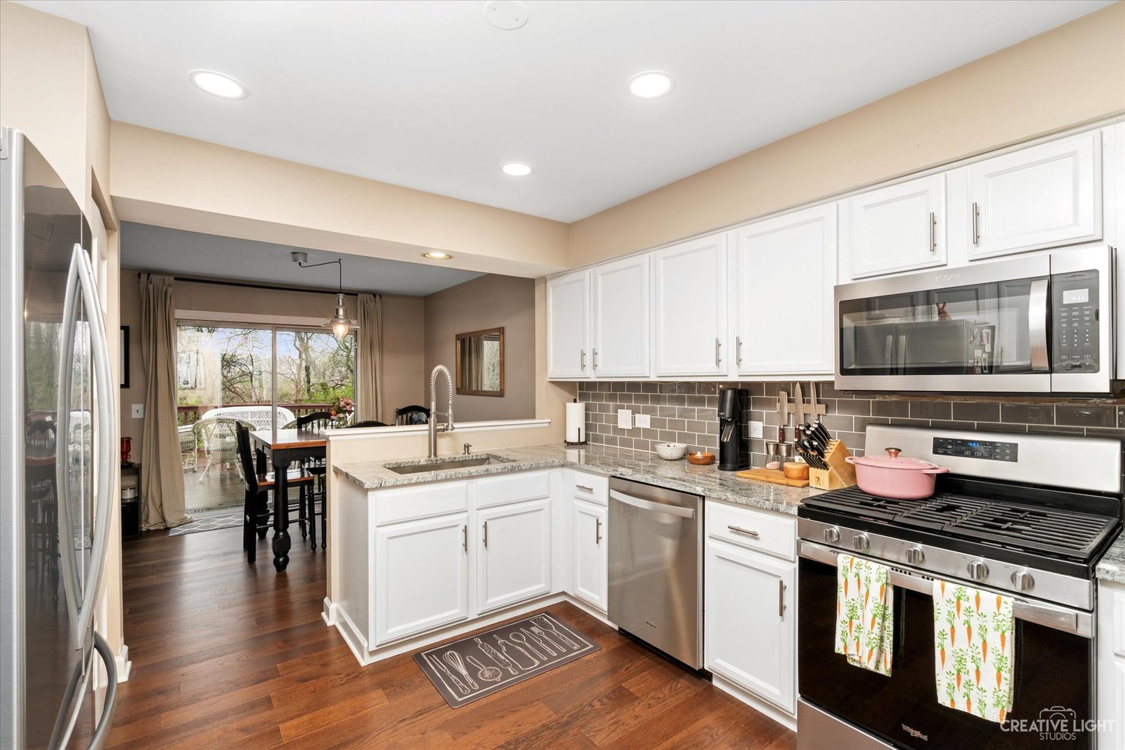 1180 Coldspring Road Elgin, IL 60120 - Photo 6 of 18 a kitchen with a sink stove and cabinets