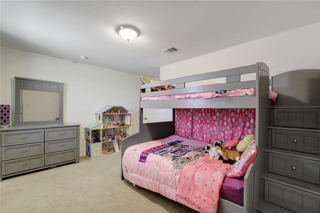 356 Matthews Kyle, TX 78640 - Photo 16 of 30 A well-lit bedroom featuring soft carpet and a convenient bunk bed with built-in storage.