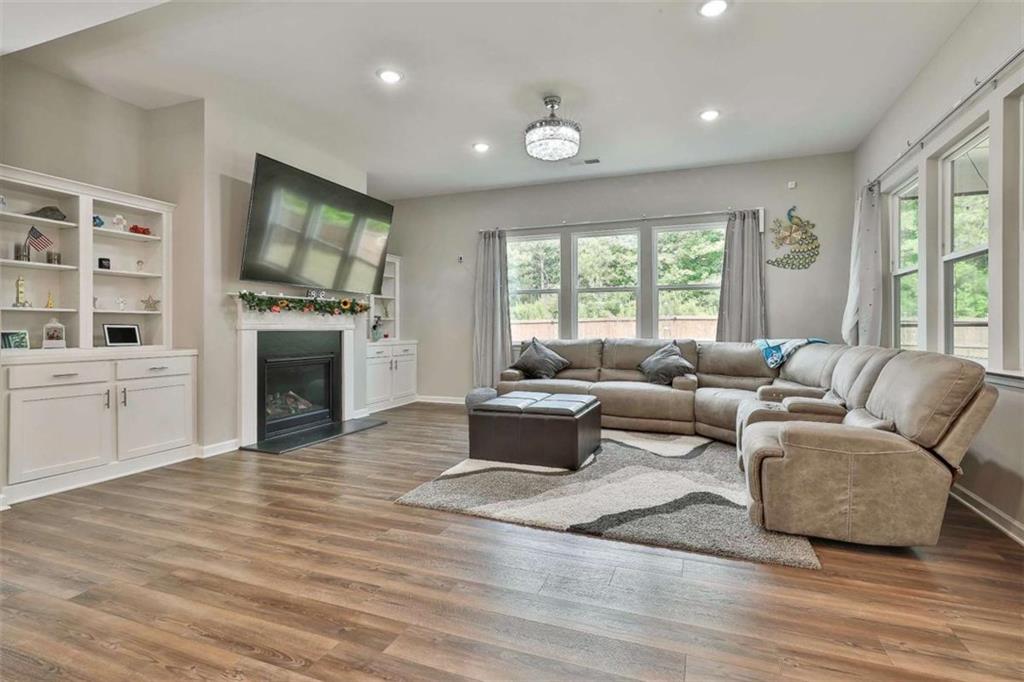 8 Unbridled Way Newnan, GA 30263 - Photo 21 of 49 a living room with furniture flat screen tv and a fireplace