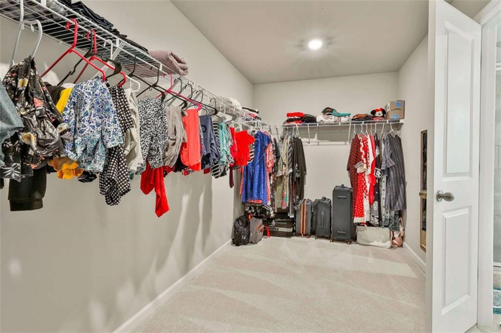 8 Unbridled Way Newnan, GA 30263 - Photo 33 of 49 a view of a walk in closet with clothes