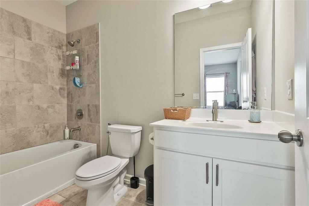 8 Unbridled Way Newnan, GA 30263 - Photo 37 of 49 a bathroom with a sink toilet vanity and shower