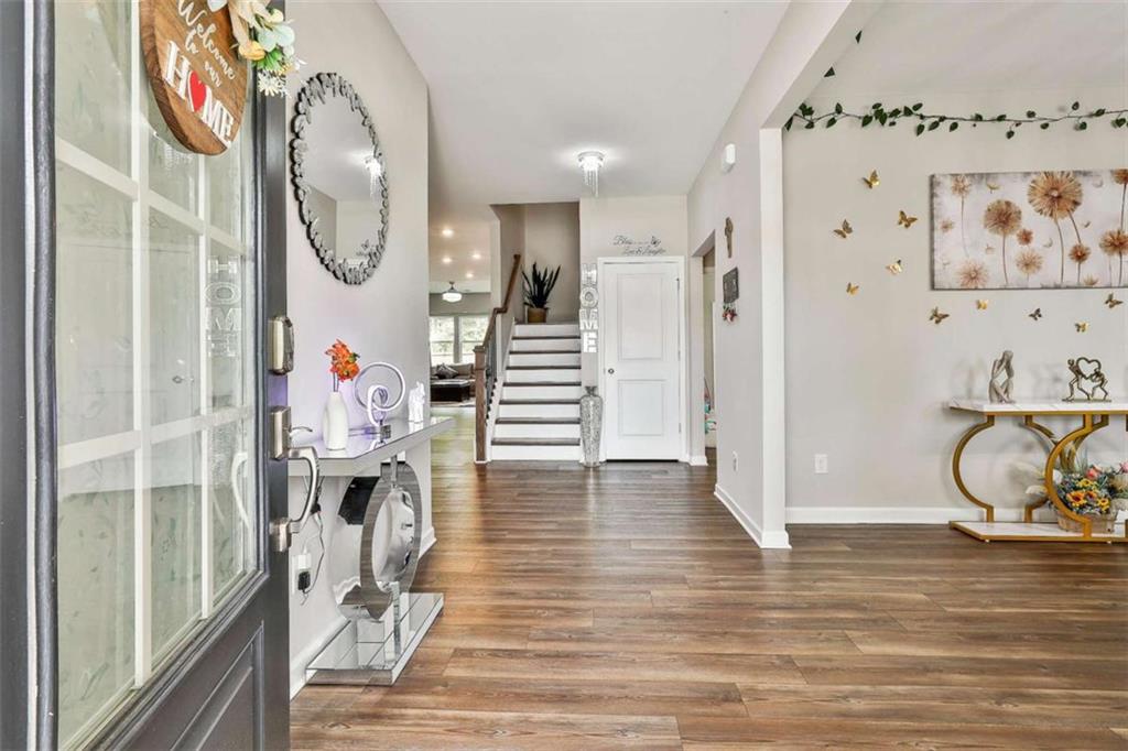 8 Unbridled Way Newnan, GA 30263 - Photo 7 of 49 a view of a hallway with wooden floor and entryway