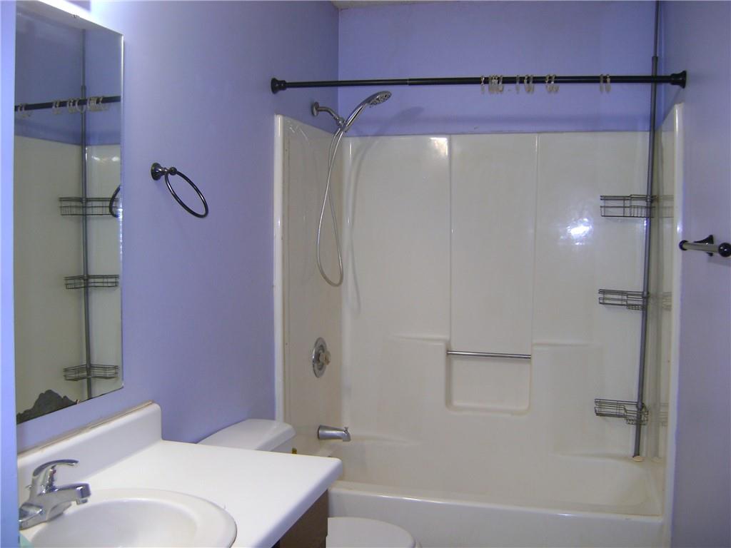 3489 East State Road Jamestown, PA 16134 - Photo 6 of 15 a bathroom with a shower curtain and a sink