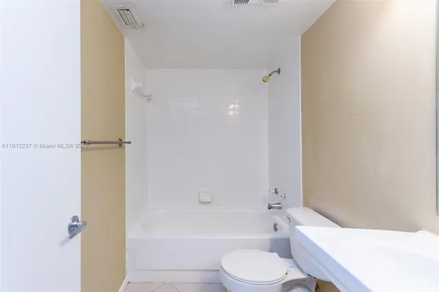 a bathroom with a bathtub toilet and sink