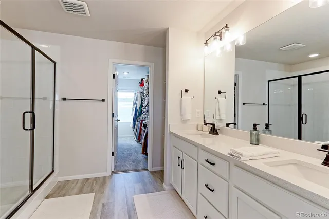 a bathroom with a double vanity sink and mirror