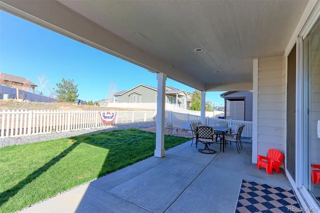 a view of a backyard with sitting area