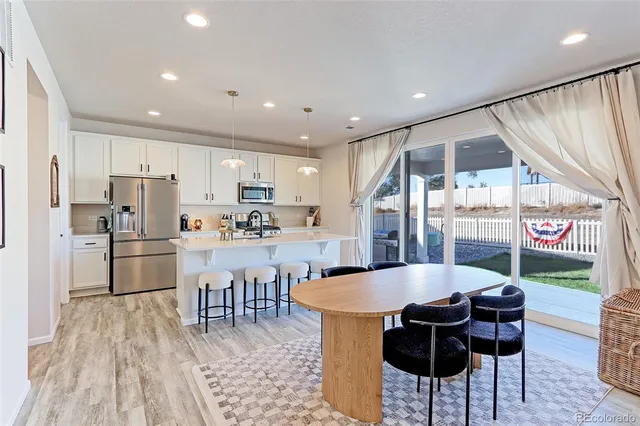 a large kitchen with a table and chairs