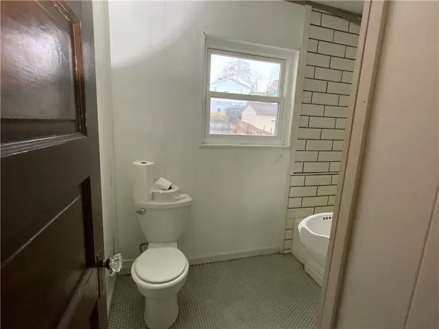 a white toilet sitting next to a bathroom sink