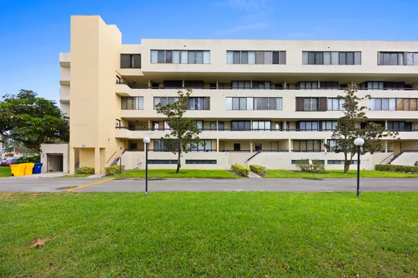 a view of a building with a yard
