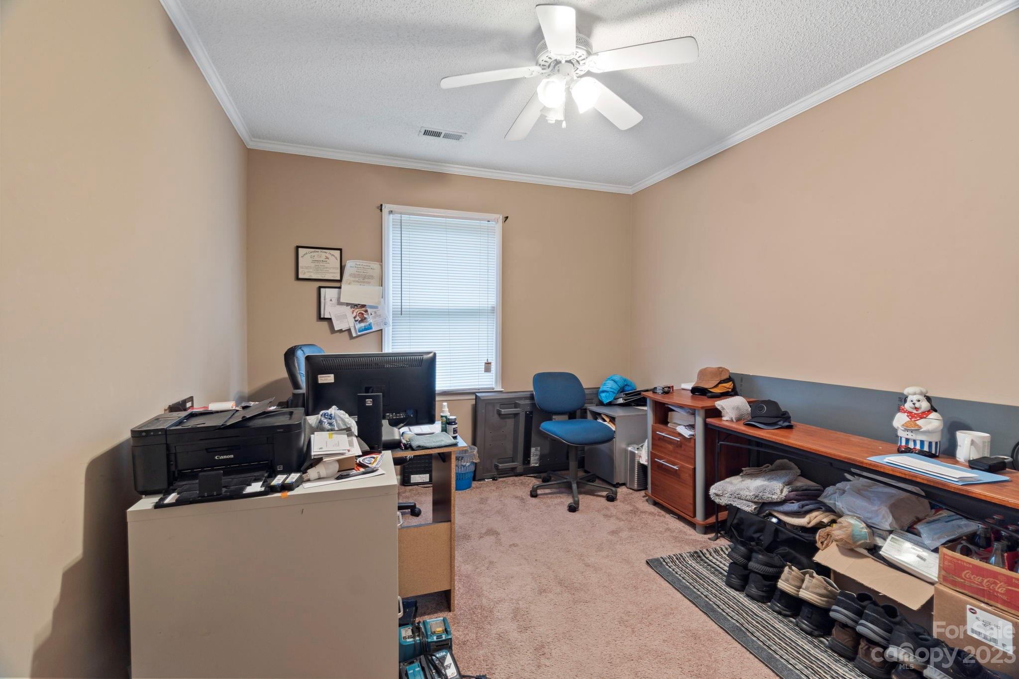 1007 Charcoal Ridge Court Matthews, NC 28105 - Photo 13 of 16 a room with furniture a chandelier fan and a window