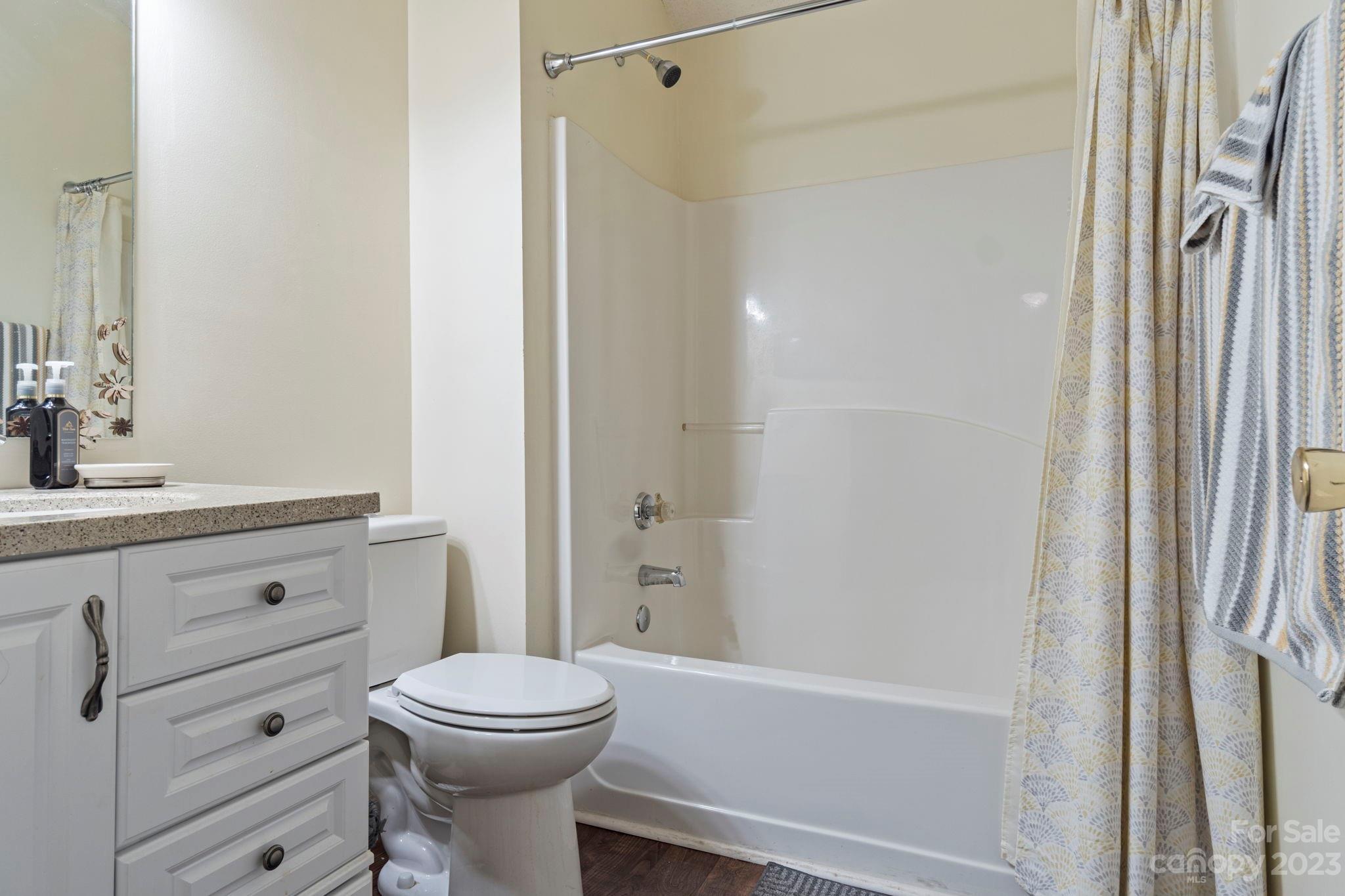 1007 Charcoal Ridge Court Matthews, NC 28105 - Photo 14 of 16 a bathroom with a toilet a sink and a bathtub