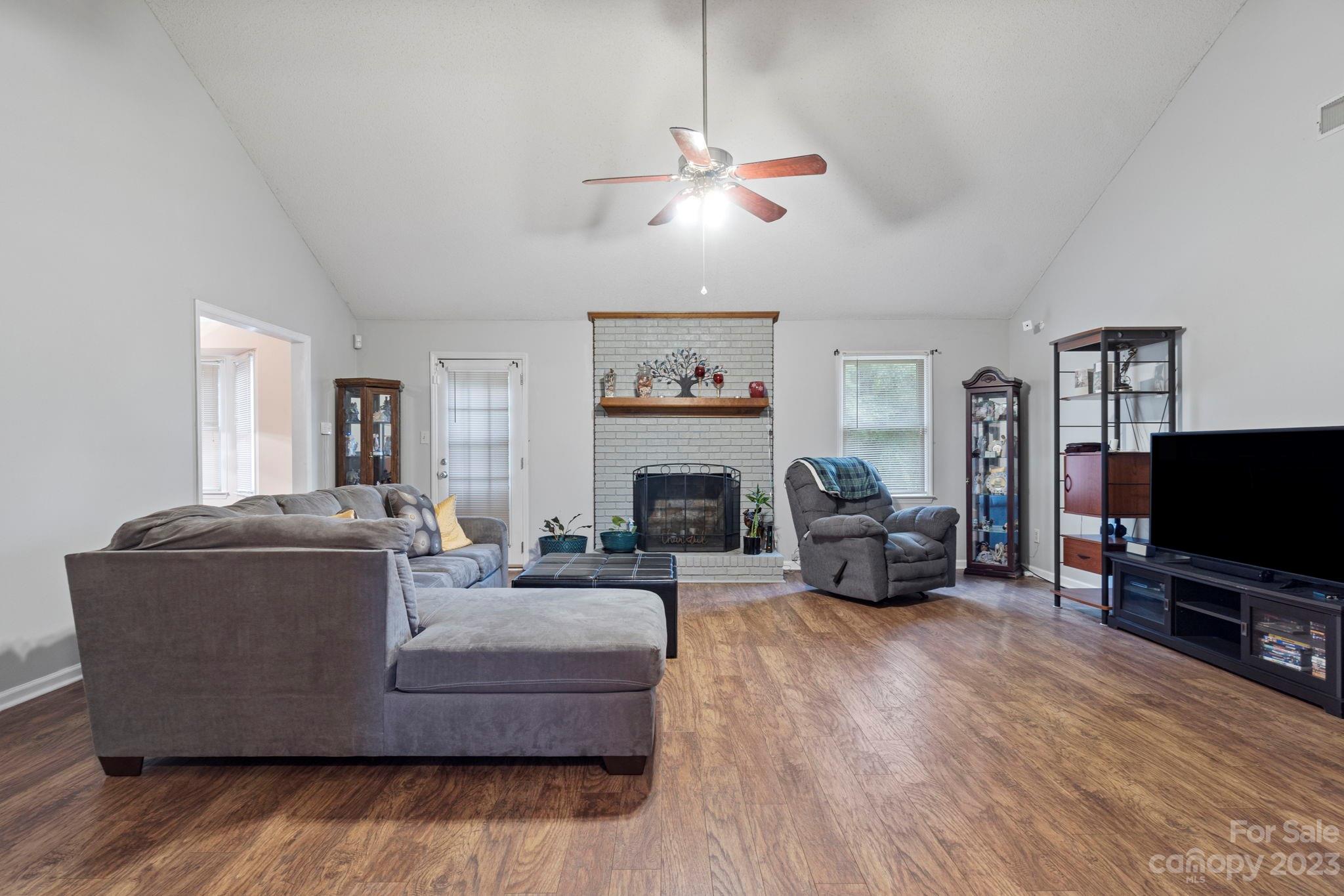 1007 Charcoal Ridge Court Matthews, NC 28105 - Photo 2 of 16 a living room with furniture a fireplace and a flat screen tv