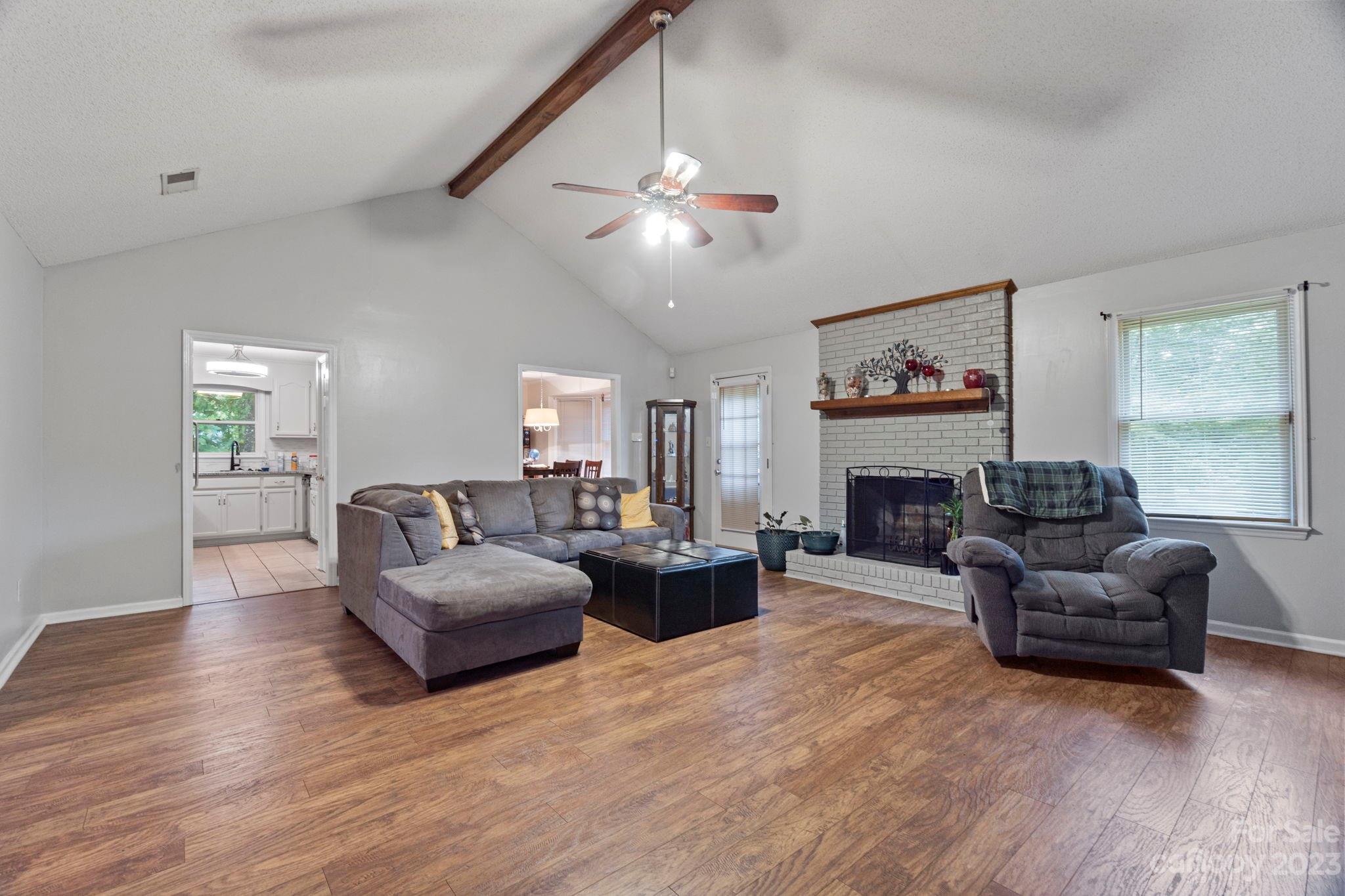1007 Charcoal Ridge Court Matthews, NC 28105 - Photo 3 of 16 a living room with fireplace furniture and a wooden floor