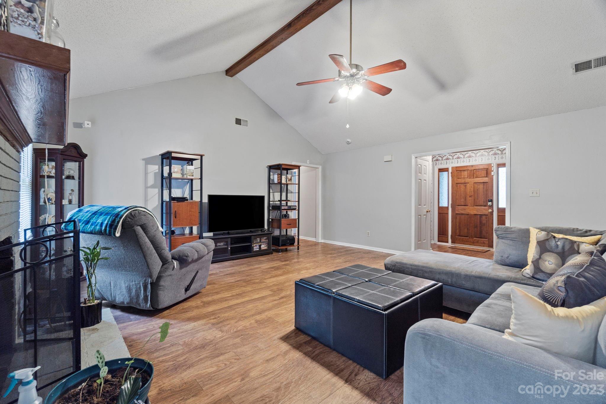 1007 Charcoal Ridge Court Matthews, NC 28105 - Photo 4 of 16 a living room with furniture flat screen tv and a window