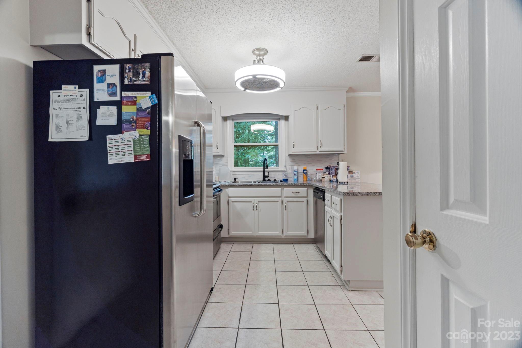 1007 Charcoal Ridge Court Matthews, NC 28105 - Photo 6 of 16 a kitchen with a sink cabinets and window