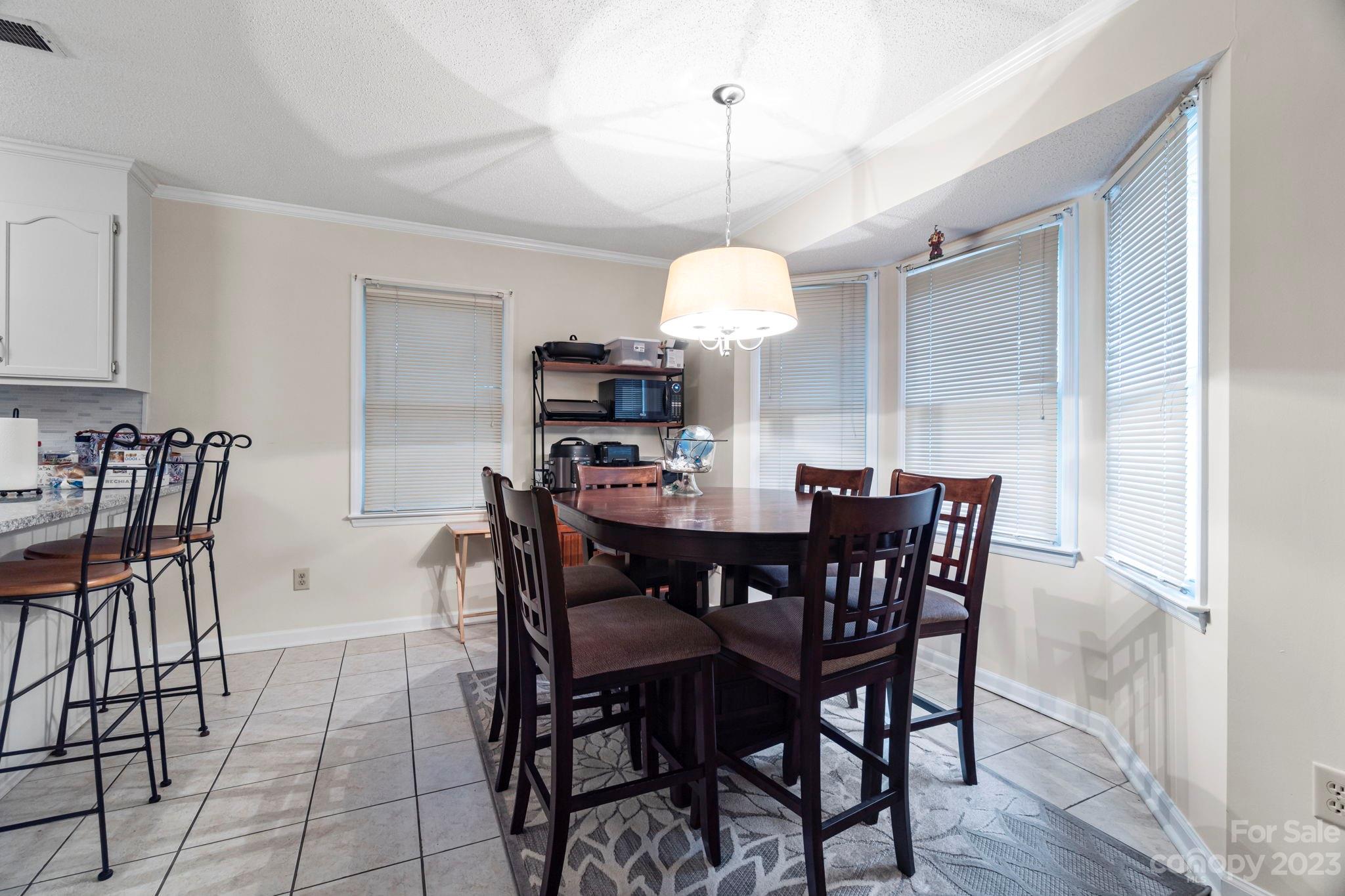 1007 Charcoal Ridge Court Matthews, NC 28105 - Photo 7 of 16 a view of a dining room and a wooden floor