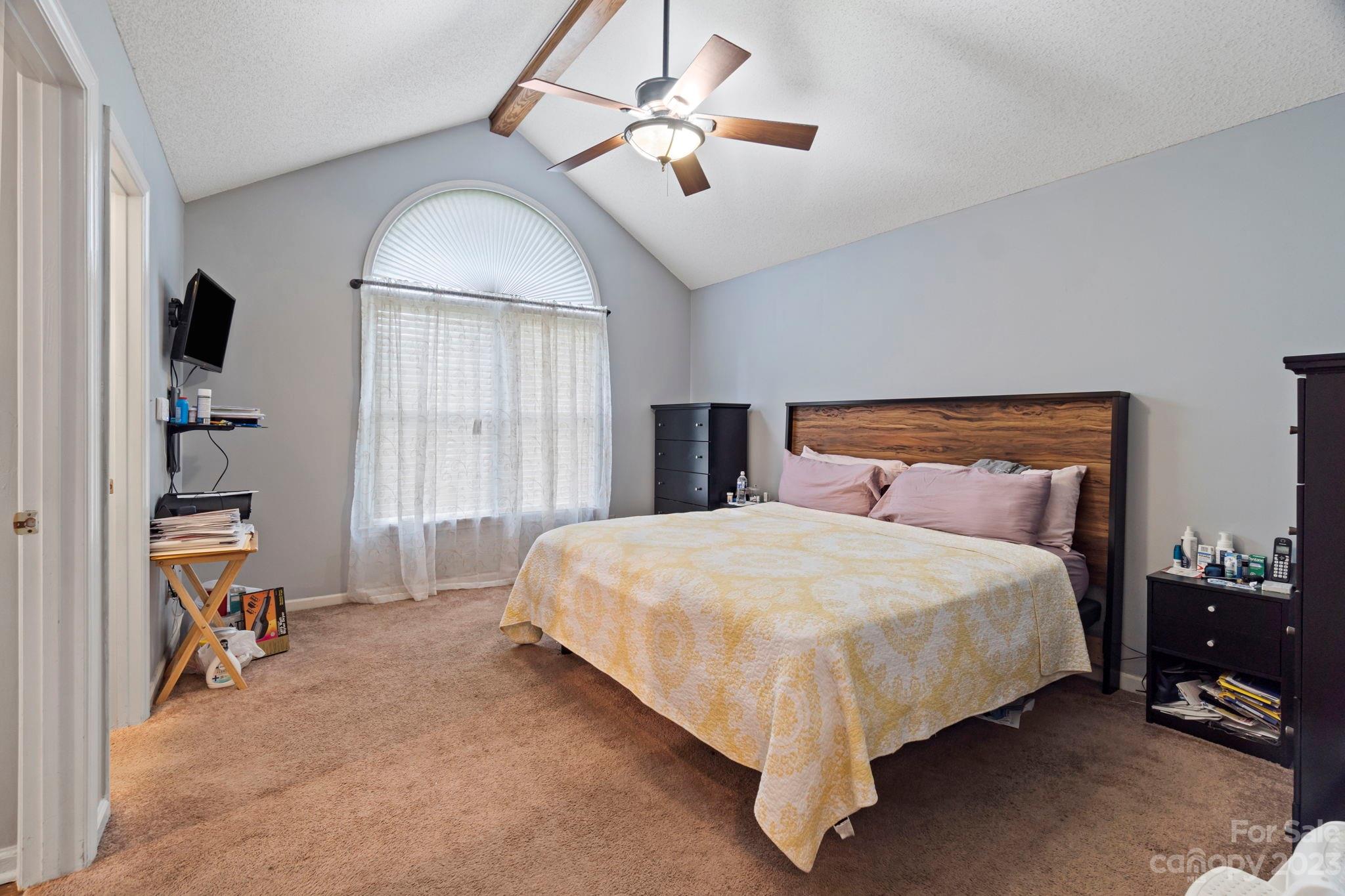 1007 Charcoal Ridge Court Matthews, NC 28105 - Photo 8 of 16 a bed room with a bed and a chandelier