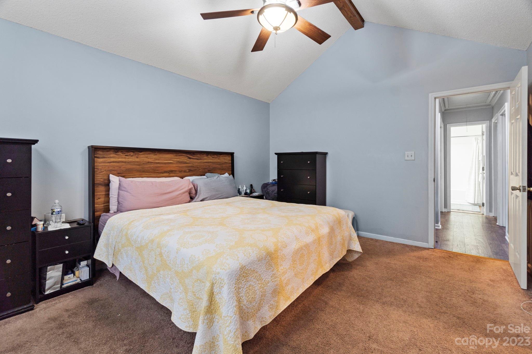 1007 Charcoal Ridge Court Matthews, NC 28105 - Photo 9 of 16 a bedroom with a bed and ceiling fan