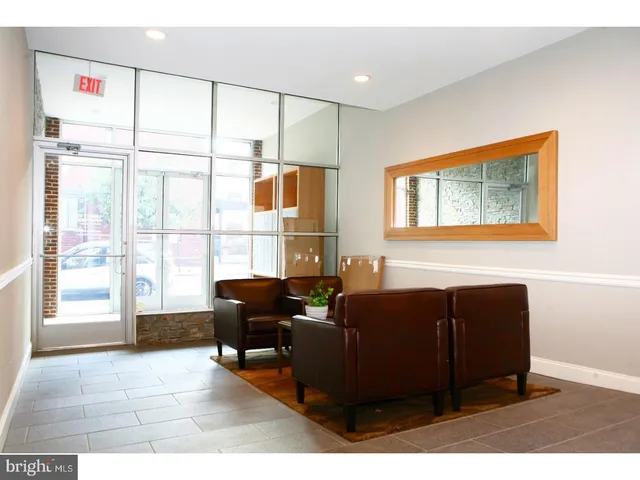 a living room with furniture and large windows