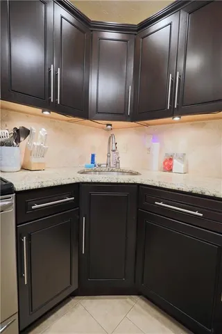 a kitchen with granite countertop stainless steel appliances and sink