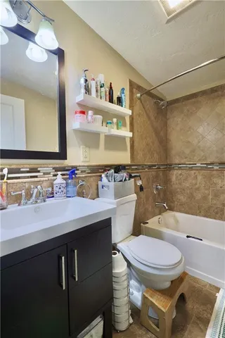 a bathroom with a sink a toilet and a mirror