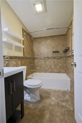 a bathroom with a toilet a sink and bathtub