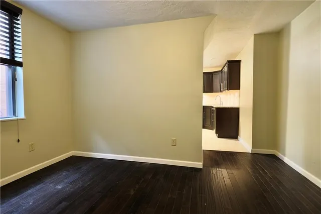 a view of wooden floor and brick walls