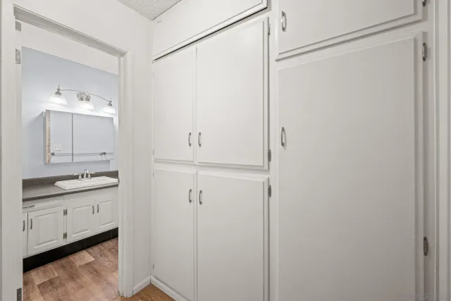 a bathroom with a granite countertop sink a mirror and a shower