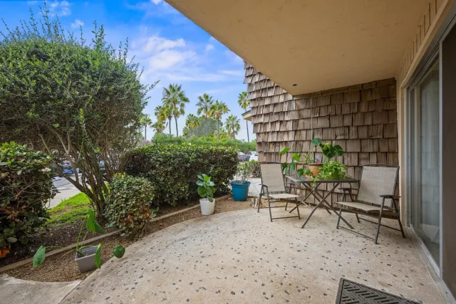 a view of a chairs and table in a backyard