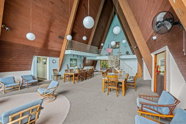 a dining room with furniture and a large window